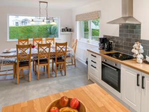 a kitchen and dining room with a table and chairs at Fourwinds in Keswick