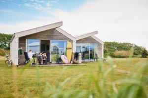 a group of people sitting in front of a house at Apelvikstrand in Varberg