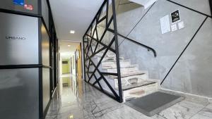 a lobby with a staircase in a building at Urbano Luxury Hotel in Pasto +26 photos