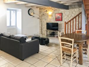 a living room with a couch and a table at Maison de village à Puybrun in Puybrun