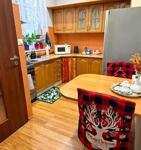 a kitchen with a table and a refrigerator at Apartament Julia Jedności in Zielona Góra +2 photos