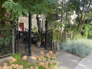 a garden with a gate and a house at Apartament Julia Jedności in Zielona Góra