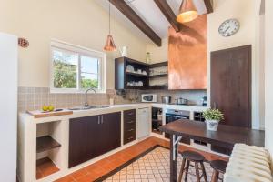 a kitchen with a sink and a table at Villa Mig Coster - Refugio rural en finca privada in Sant Lluis