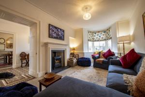 a living room with two couches and a fireplace at The Old Manse in Leyburn