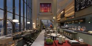 a restaurant with a view of a city at Mehood Elegant Hotel Panyu Chimelong Wanbo in Guangzhou
