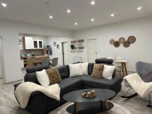 a living room with a couch and a table at SleepShop in Nordhausen