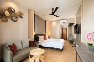 a hotel room with a bed and a couch at Amankara Canggu in Canggu
