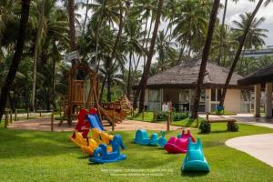 a playground with colorful plastic toys on the grass at Jatiúca Suítes Resort - Flat 413 in Maceió