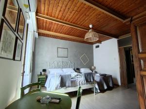 a bedroom with a bed and a table in it at I Vespri in Catania