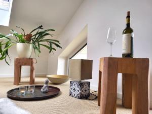 a room with a table with a bottle of wine and glasses at Haus Theda in Fockbek +44 photos