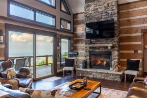 a living room with a fireplace and a television at Above and Beyond in Boone