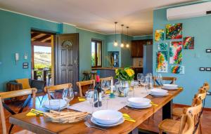 a dining room with a long wooden table with chairs at Villa Traiani 8&2 by Marche Holiday Villas in Piagge