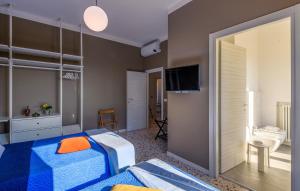 a bedroom with a blue bed and a bathroom at Villa Traiani 8&2 by Marche Holiday Villas in Piagge +34 photos