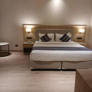 a bedroom with a large bed and two night stands at Bluestone Prime by The Cosy Hotels in New Delhi