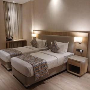 a hotel room with two beds in a room at Bluestone Prime by The Cosy Hotels in New Delhi +25 photos