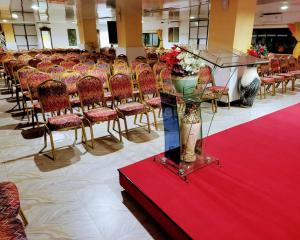 a room with a bunch of chairs and a table with flowers at Rusty Rock Beach Resort & Spa in Mwanza