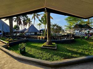 a park with a palm tree in the grass at Rusty Rock Beach Resort & Spa in Mwanza