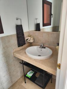 a bathroom with a sink and a mirror at Ático de lujo con vistas al mar in Estepona