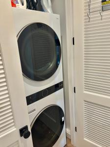 a microwave oven in a wall next to a door at Luxe Home Near DTLA & Dodgers with Rooftop in Los Angeles