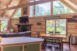 a living room with a fireplace in a log cabin at Serenity Now in Fleetwood