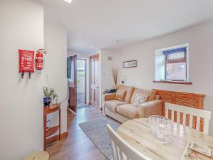 a living room with a table and a couch at Ben View in Aberlour
