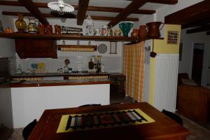 a kitchen with a wooden table and a counter top at Villa Nunzia in Cupramontana