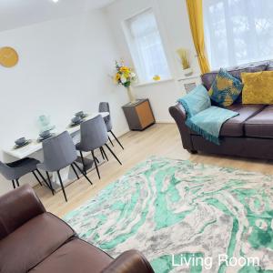 a living room with a couch and a table at Immaculate Haven in Westhoughton