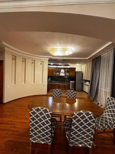 a living room with a table and chairs at 4х На берегу Иртыша in Pavlodar +1 photo