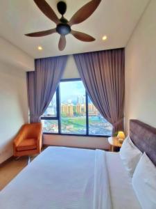 a bedroom with a ceiling fan and a large window at Lucentia Suites klcc by SkyPool in Kuala Lumpur