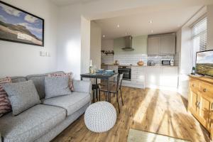 a living room with a couch and a table at California Cottage 2 in Middleton in Teesdale