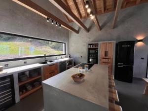 a kitchen with a large island in the middle of it at Casa do Atalho in Santo Amaro
