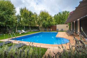 a swimming pool in the backyard of a house at Turismo Rural Mas Ametller in Fontclara