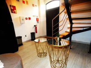 a living room with a table and a staircase at Pinhal Litoral in Marinha Grande
