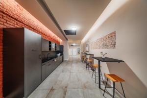 a kitchen with a long corridor with tables and chairs at District One - Hideaway Hostel in Vienna