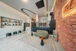 a living room with a brick wall at District One - Hideaway Hostel in Vienna