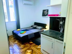 a small room with a bed and a sink in it at Pula-Center Studio Apartments in Pula