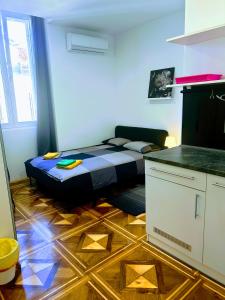 a bedroom with a bed in a room with a kitchen at Pula-Center Studio Apartments in Pula