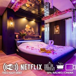 a room with a purple bed with a cake on it at La prestigieuse Sauna Balnéo Ciné in Roannes-Saint-Mary