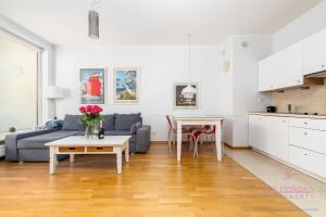 ein Wohnzimmer mit Sofa und Tisch in der Unterkunft Your Holidays Aquamarina in Misdroy