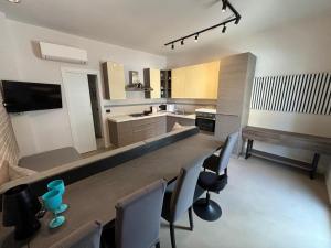 a large kitchen with a long table and chairs at Typic loft Alghero in Alghero