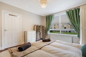 a bedroom with a large bed and a window at Free Parking - Central - Sleeps 6 - Great Location in Armadale +11 photos