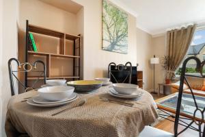 a dining room table with bowls and plates on it at Free Parking - Central - Sleeps 6 - Great Location in Armadale