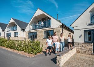 a group of people standing in front of a house at Windmill Retreat in Middlezoy +17 photos