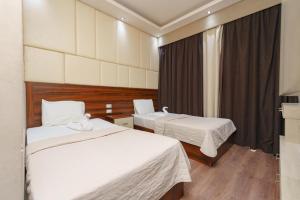 Ένα ή περισσότερα κρεβάτια σε δωμάτιο στο Elite Grand City