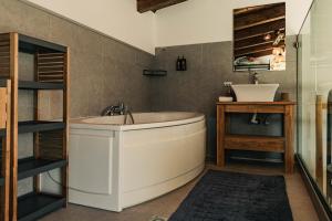 a bathroom with a tub and a sink at Mont Rock in Synikia Mesi Trikalon +25 photos