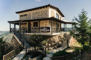 a house on the side of a mountain with stairs at Mont Rock in Synikia Mesi Trikalon