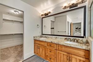 a bathroom with a sink and a large mirror at Windriver Hideaway - Private Hot Tub in Wolf Creek Village +50 photos