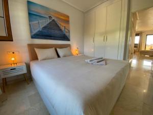 a large white bed in a bedroom with two lamps at Casa Kessing in Orihuela Costa +20 photos