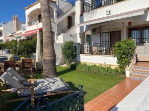 a balcony of a house with a palm tree at Casa Kessing in Orihuela Costa