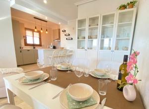 a dining table with plates and glasses on it at Casa Kessing in Orihuela Costa